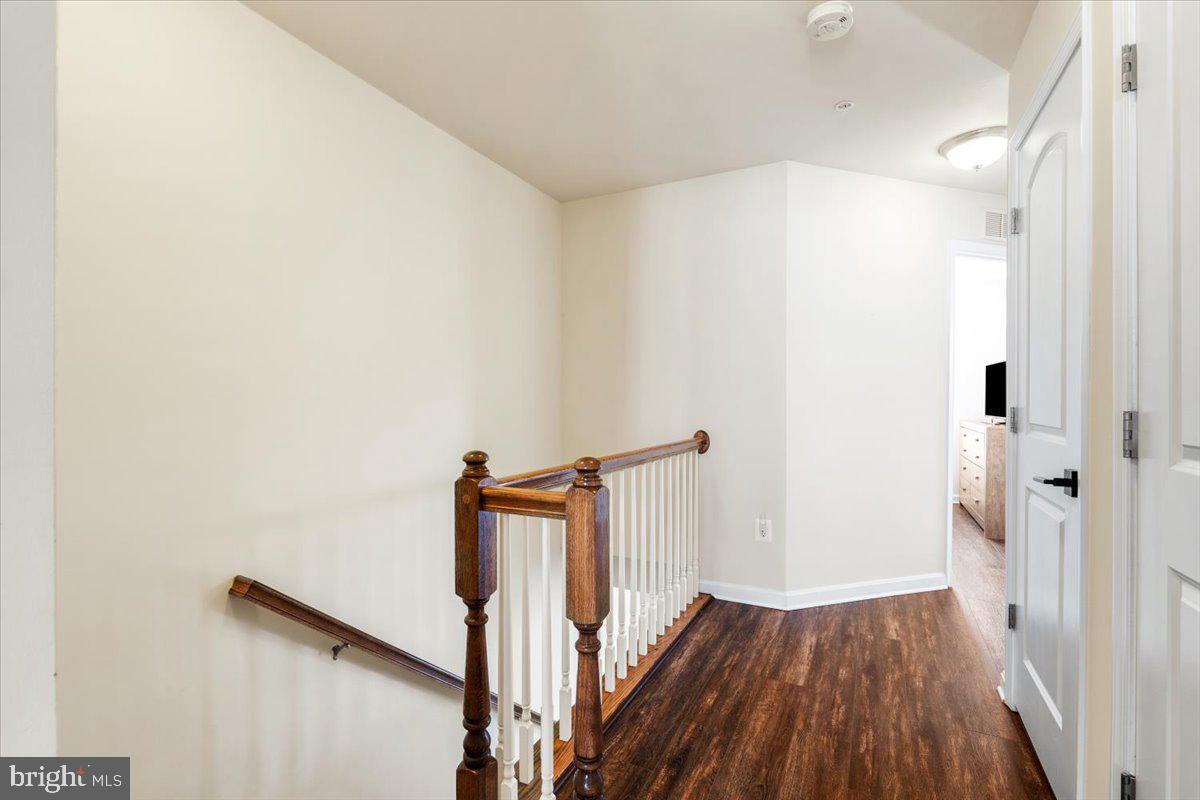 6500 Newton Drive Frederick, MD 21703 - Photo 15 of 36 a view of a hallway with wooden floor