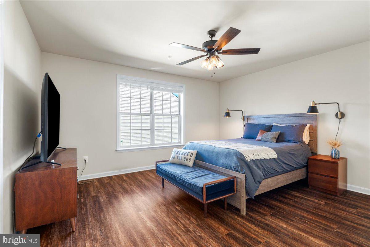 6500 Newton Drive Frederick, MD 21703 - Photo 18 of 36 a bedroom with a bed and wooden floor