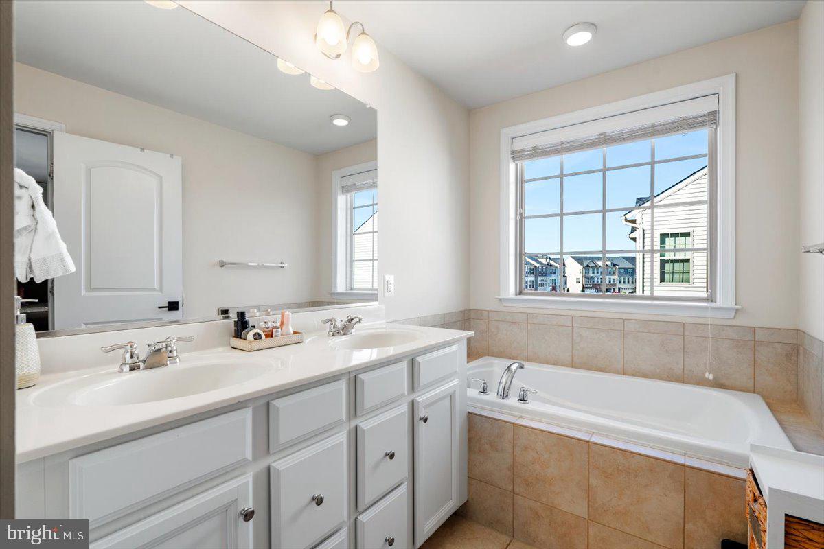 6500 Newton Drive Frederick, MD 21703 - Photo 19 of 36 a bathroom with a tub a sink and mirror