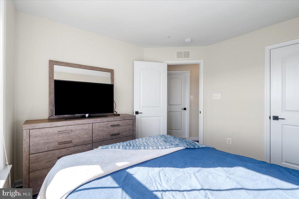 6500 Newton Drive Frederick, MD 21703 - Photo 22 of 36 a bedroom with a bed and a flat screen tv
