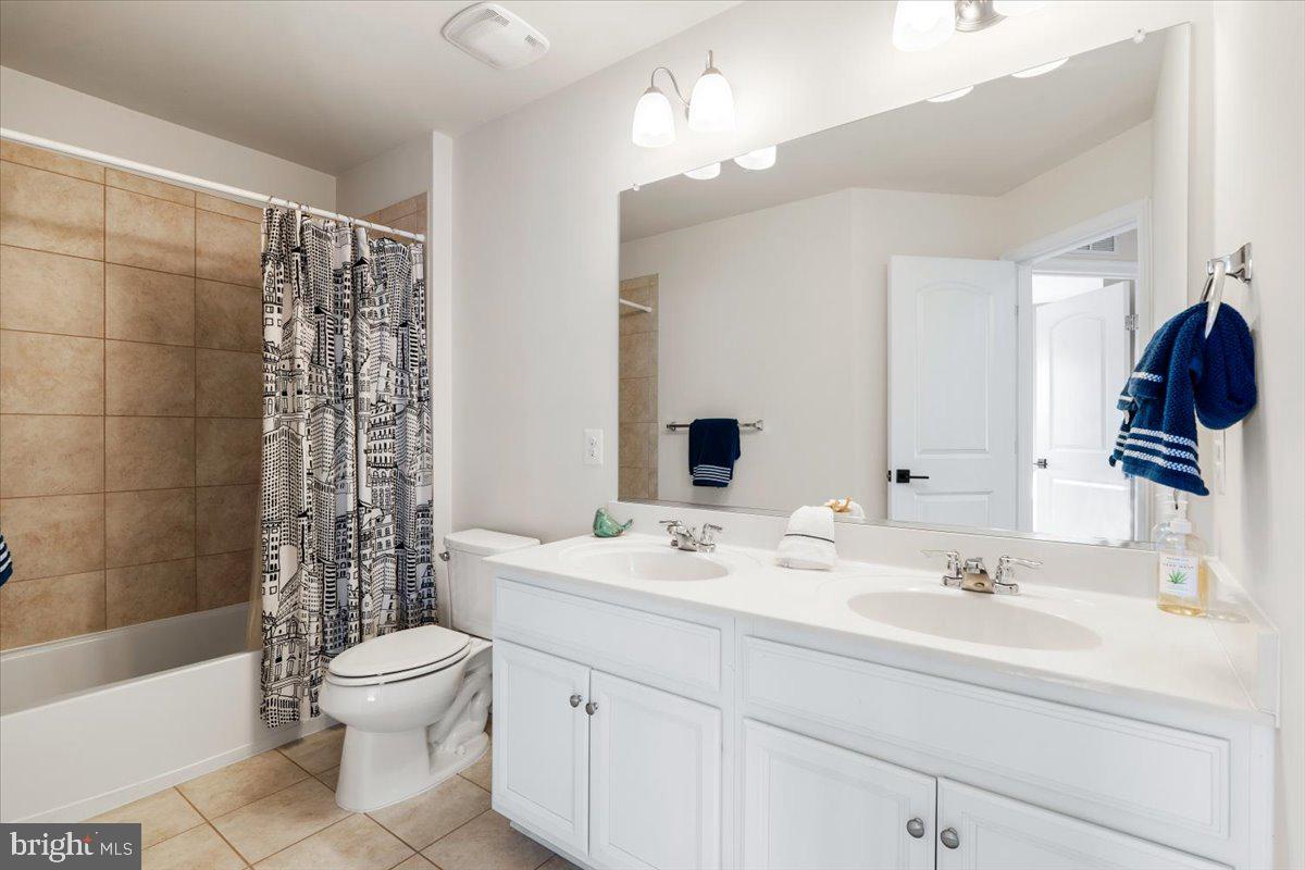 6500 Newton Drive Frederick, MD 21703 - Photo 23 of 36 a bathroom with a sink a toilet and shower