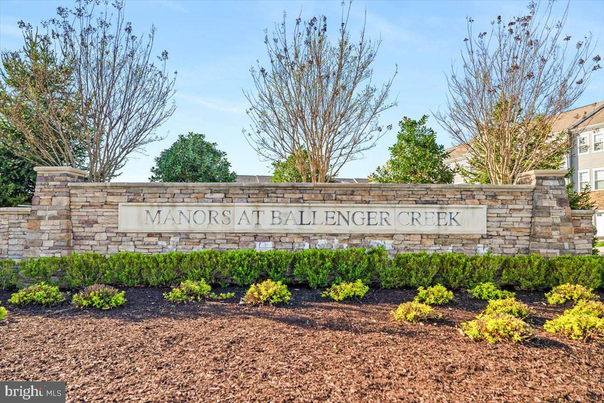 6500 Newton Drive Frederick, MD 21703 - Photo 36 of 36 a street sign that is sitting in the middle of a garden