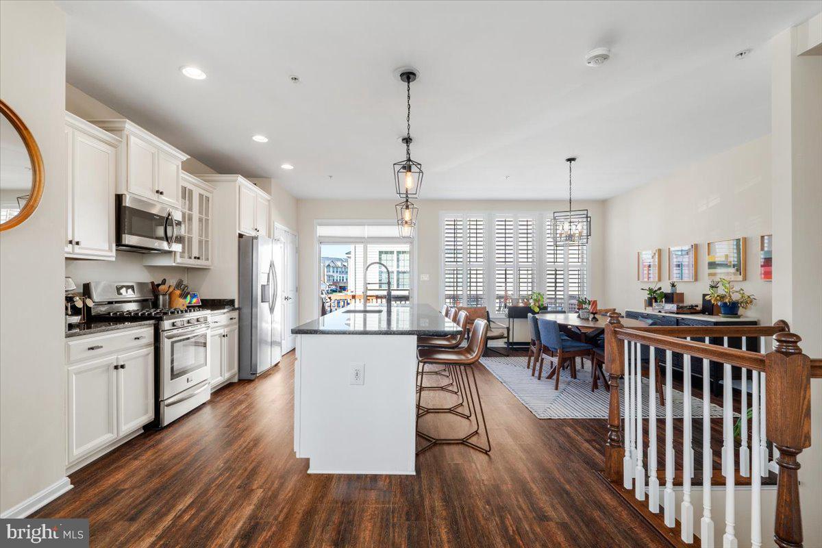 6500 Newton Drive Frederick, MD 21703 - Photo 9 of 36 a kitchen with stainless steel appliances granite countertop sink stove top oven and cabinets