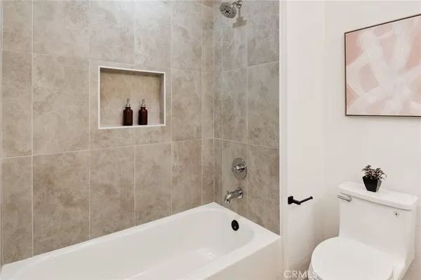 a bathroom with a toilet and a tub