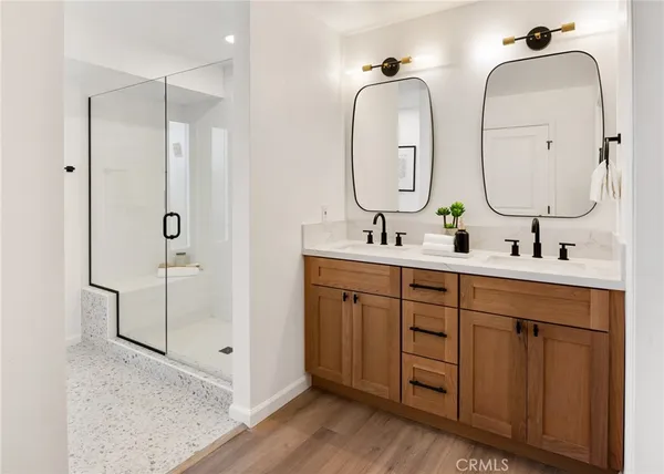 a bathroom with 2 sink and a mirror