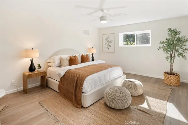 a bedroom with a bed and a potted plant