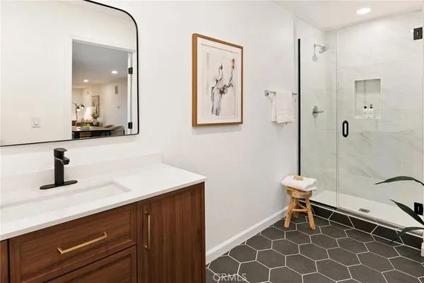 a bathroom with a sink a mirror and a shower