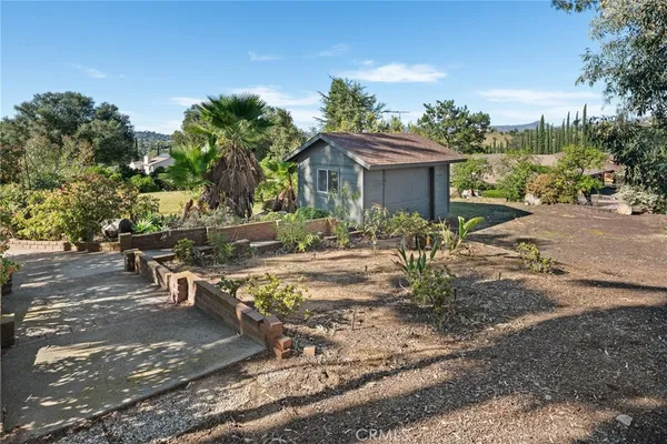a view of a house with backyard and sitting area