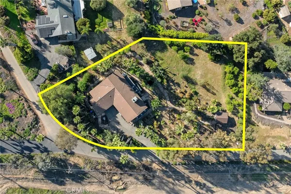 an aerial view of residential house with green space
