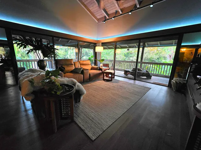 a living room with furniture and large windows