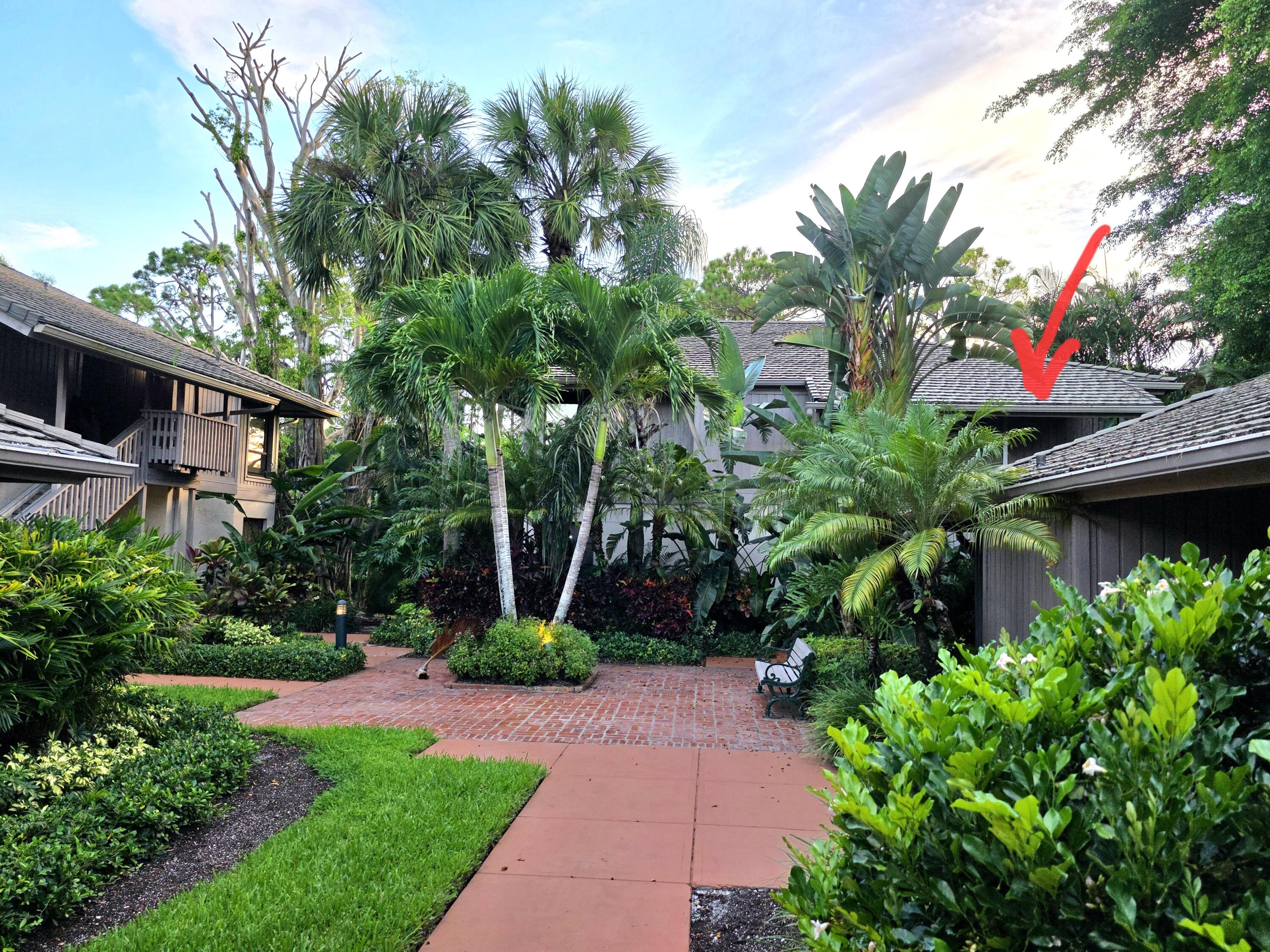 6957 Rain Forest Drive Boca Raton, FL 33434 - Photo 4 of 11 a front view of a house with garden