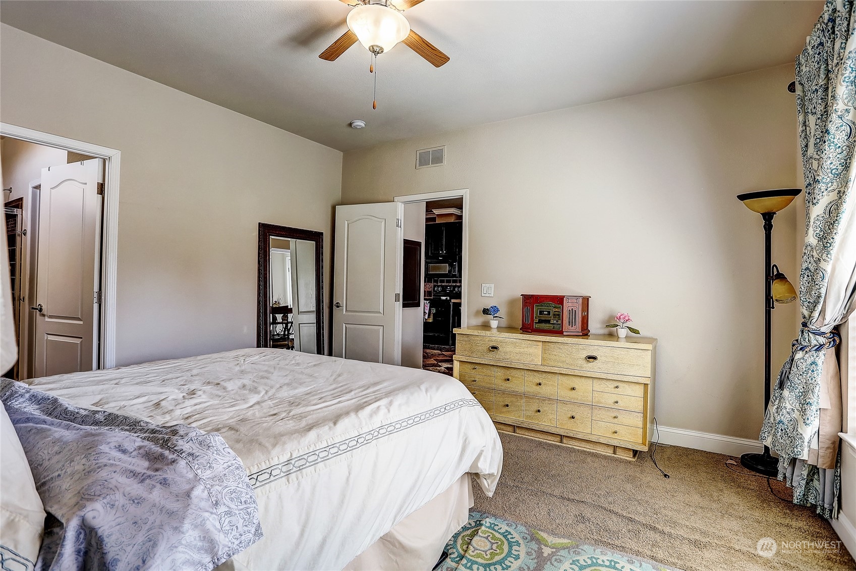 812 Pine Drive Enumclaw, WA 98022 - Photo 17 of 26 a spacious bedroom with a bed and a chandelier