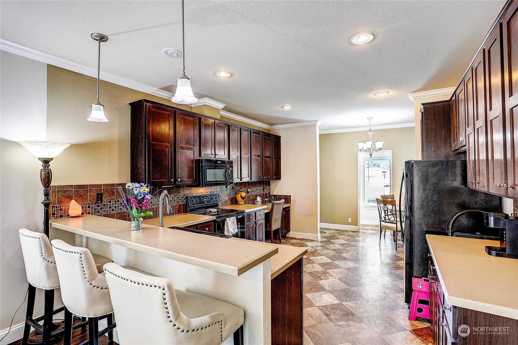 812 Pine Drive Enumclaw, WA 98022 - Photo 9 of 26 a kitchen with stainless steel appliances kitchen island granite countertop a sink refrigerator and cabinets