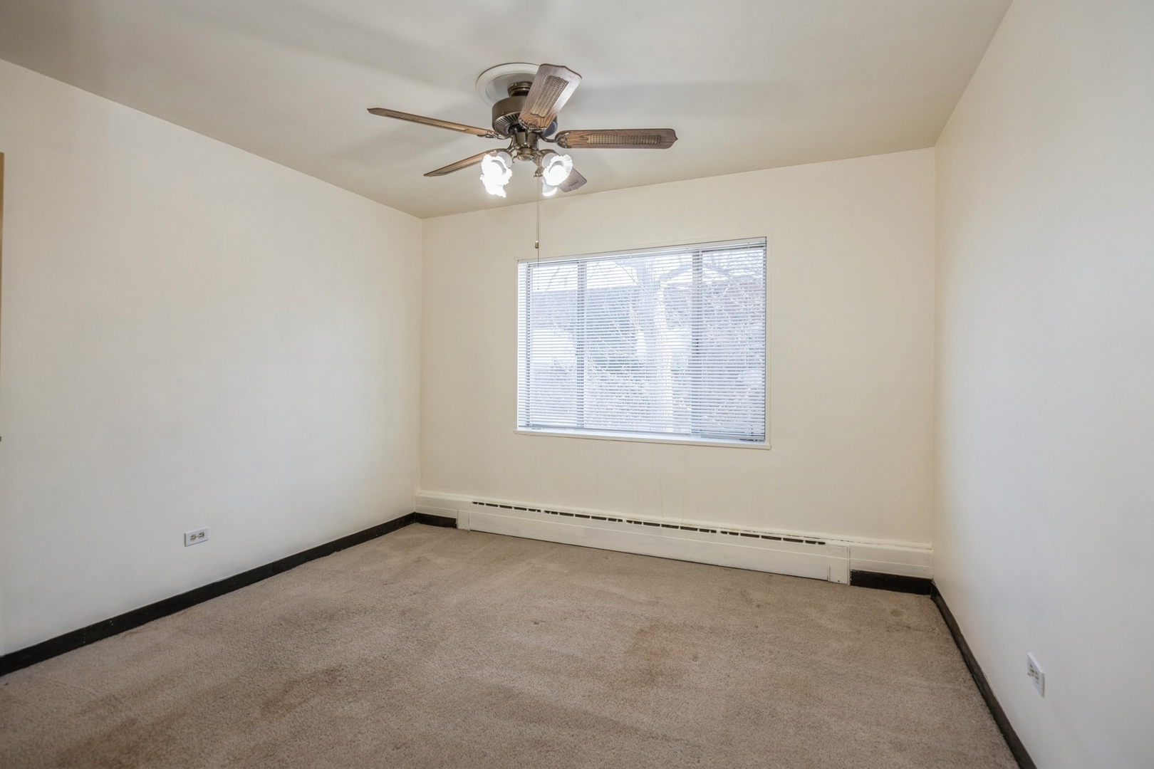 148 Ann Street, Unit 11 Clarendon Hills, IL 60514 - Photo 8 of 11 an empty room with windows and fan