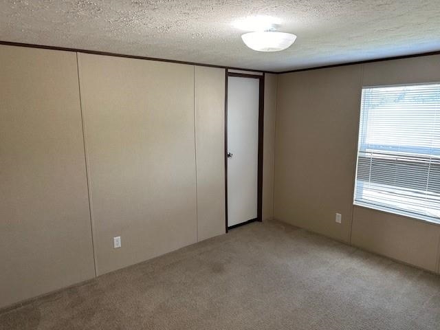 an empty room with a window and closet area