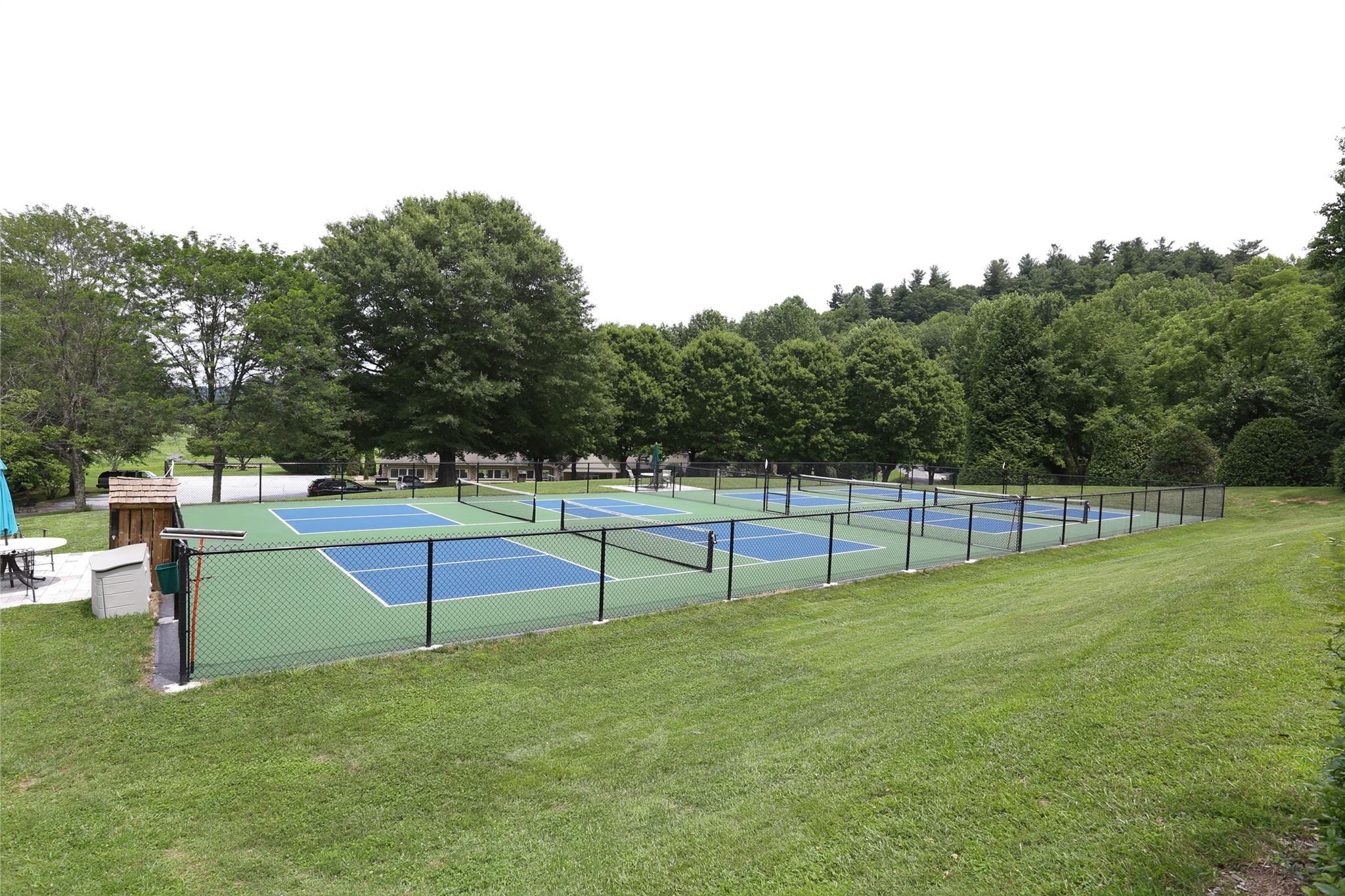 125 Burning Tree Lane Flat Rock, NC 28731 - Photo 13 of 15 a view of a green field with wooden fence