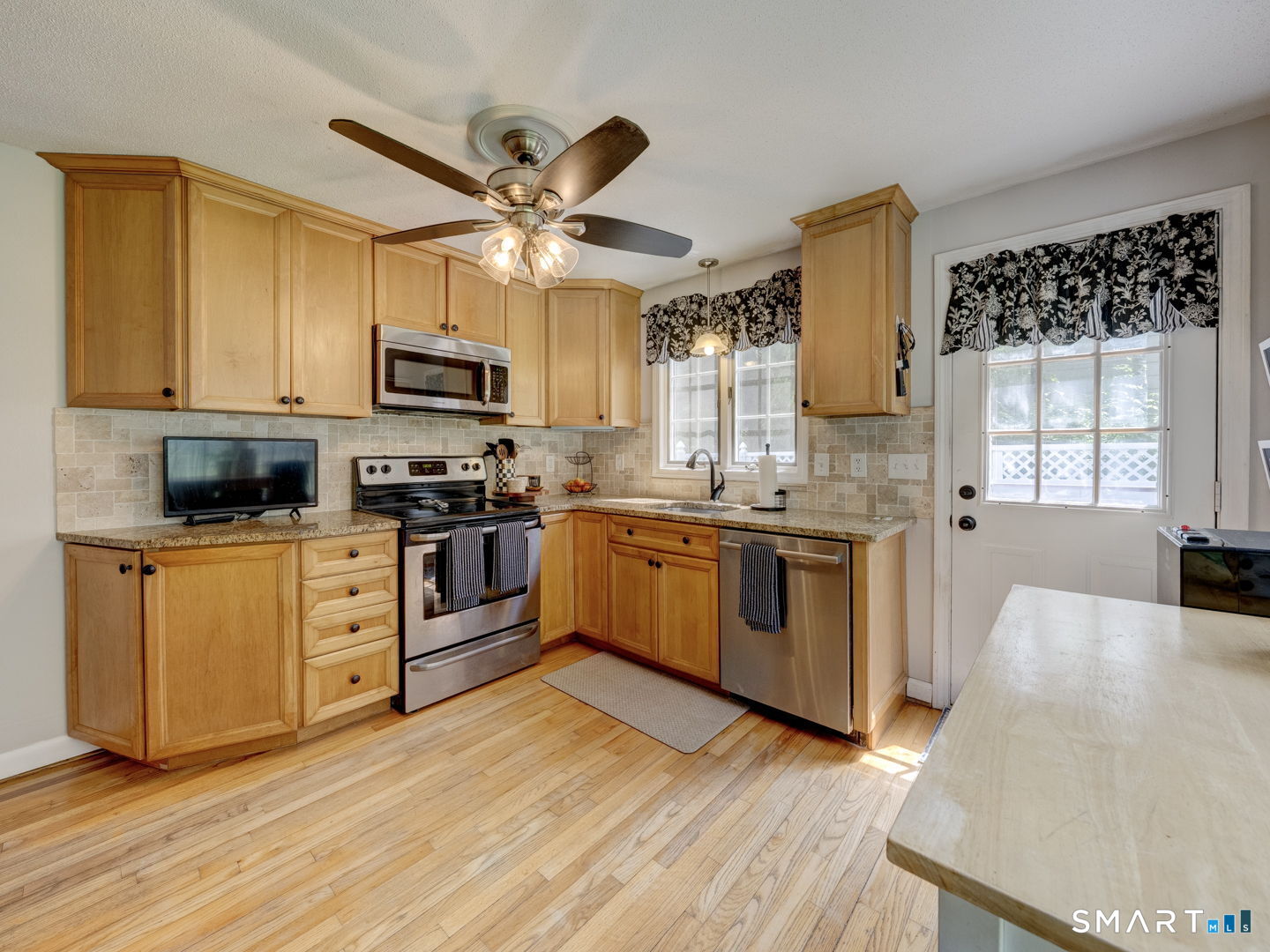39 Freedom Drive Canton, CT 06019 - Photo 10 of 37 a kitchen with stainless steel appliances granite countertop a stove a sink and a microwave