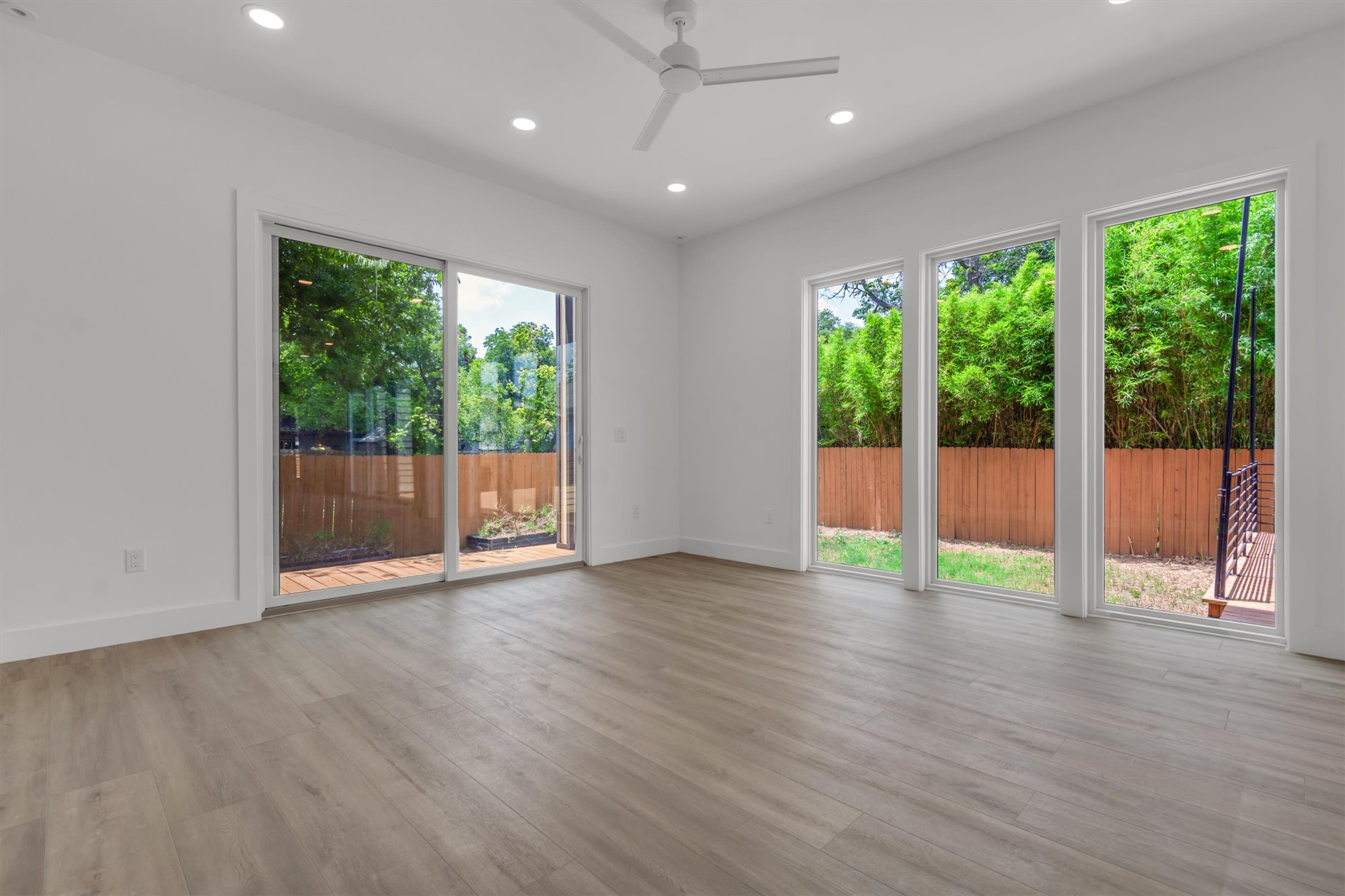 3101 Lyons Road Austin, TX 78702 - Photo 16 of 40 A spacious room offers direct outdoor access through sliding glass doors and multiple windows.