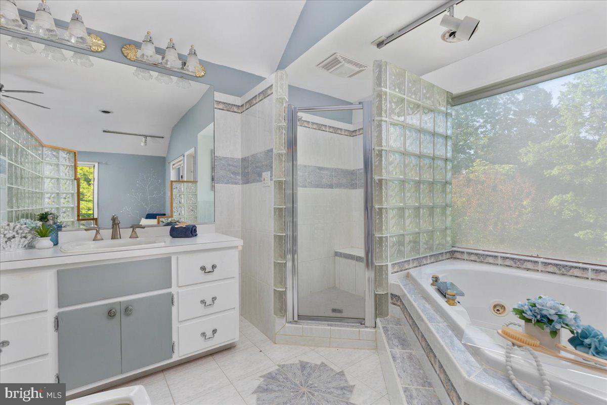 146 Lizzie Mills Road Castleton, VA 22716 - Photo 27 of 91 a bathroom with a granite countertop sink mirror bathtub and shower