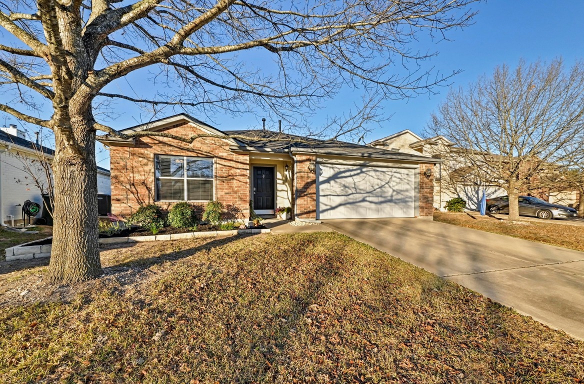280 Spruce Drive Kyle, TX 78640 - Photo 1 of 30 Ranch-style home featuring concrete driveway, brick siding, and an attached garage