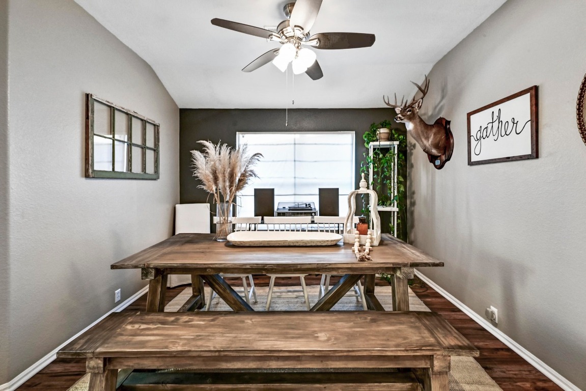 280 Spruce Drive Kyle, TX 78640 - Photo 13 of 30 Dining room with dark wood-style floors, a ceiling fan, and lofted ceiling