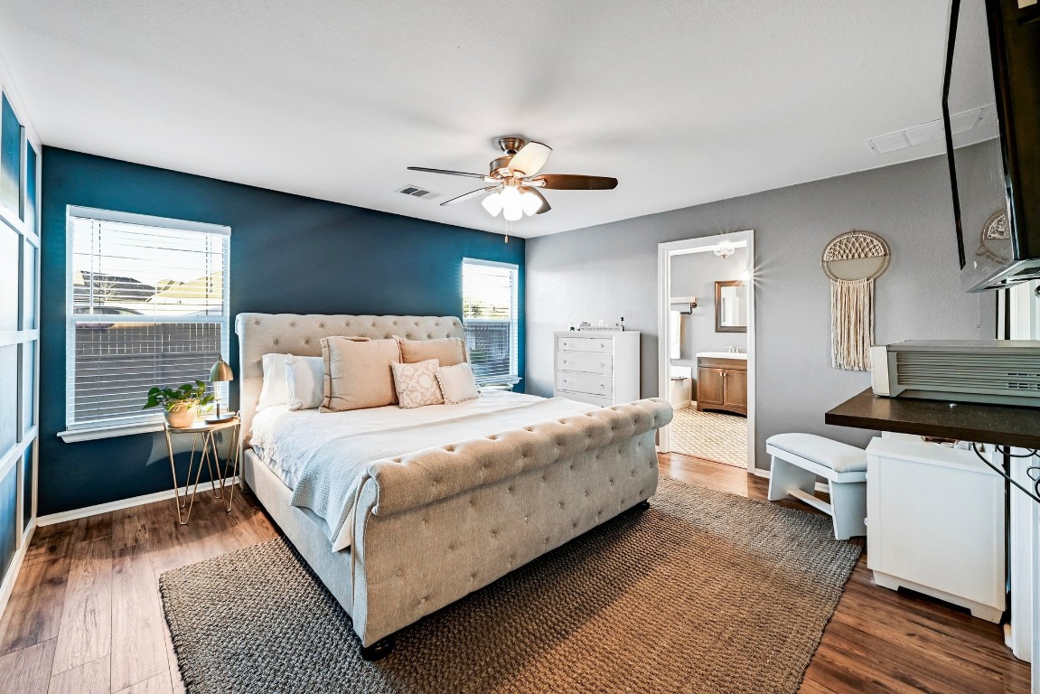280 Spruce Drive Kyle, TX 78640 - Photo 15 of 30 Bedroom with dark wood-style floors, a ceiling fan, and ensuite bath