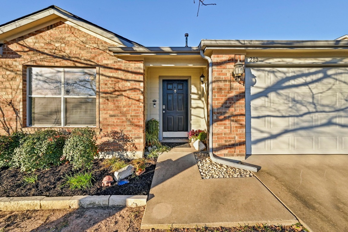 280 Spruce Drive Kyle, TX 78640 - Photo 3 of 30 Property entrance with a garage and brick siding