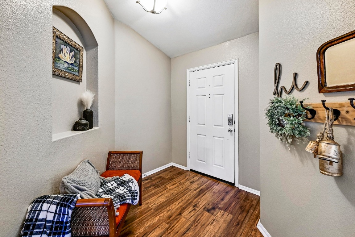 280 Spruce Drive Kyle, TX 78640 - Photo 4 of 30 Foyer entrance with a textured wall and dark wood finished floors