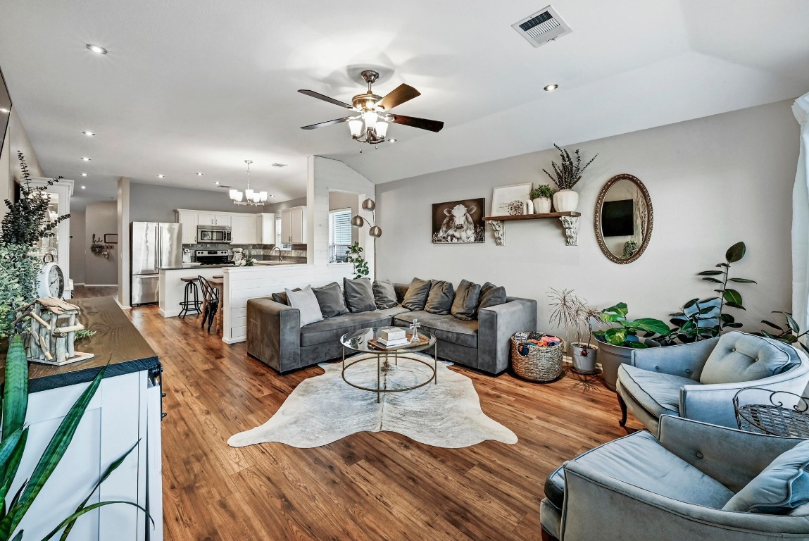 280 Spruce Drive Kyle, TX 78640 - Photo 7 of 30 Living area featuring recessed lighting, a ceiling fan, wood finished floors, vaulted ceiling, and a chandelier