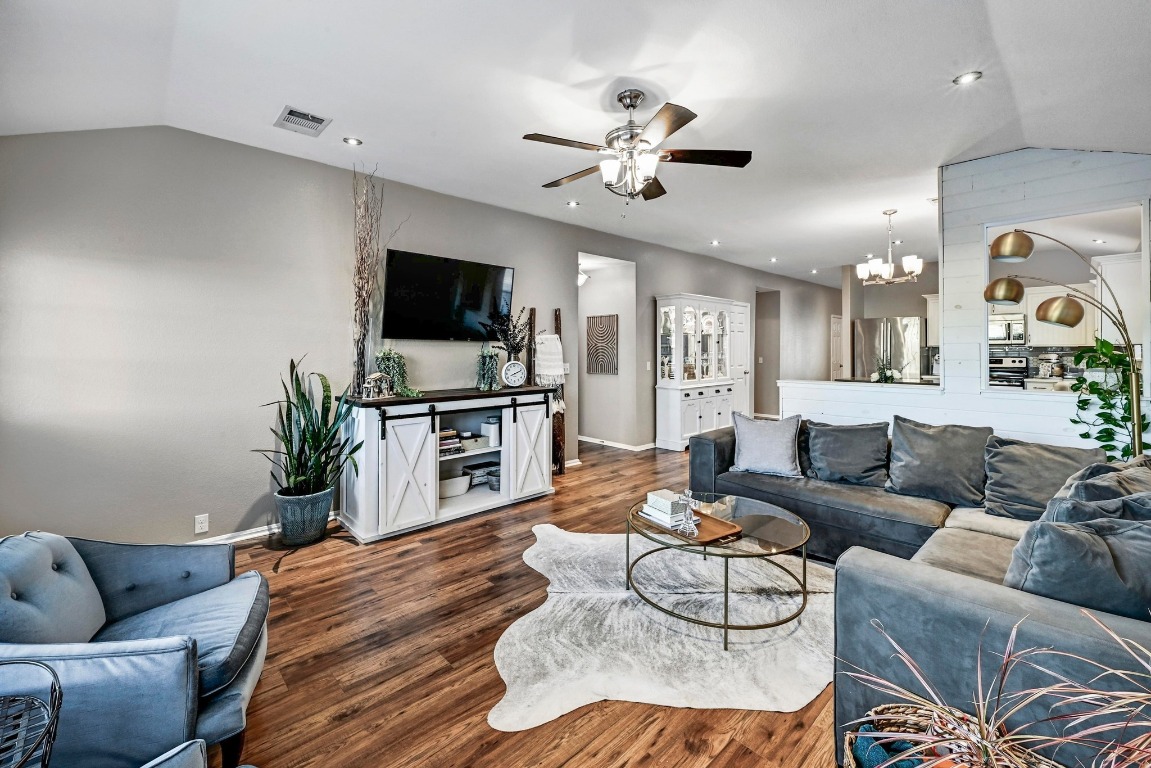 280 Spruce Drive Kyle, TX 78640 - Photo 8 of 30 Living area with lofted ceiling, ceiling fan, a chandelier, wood finished floors, and recessed lighting