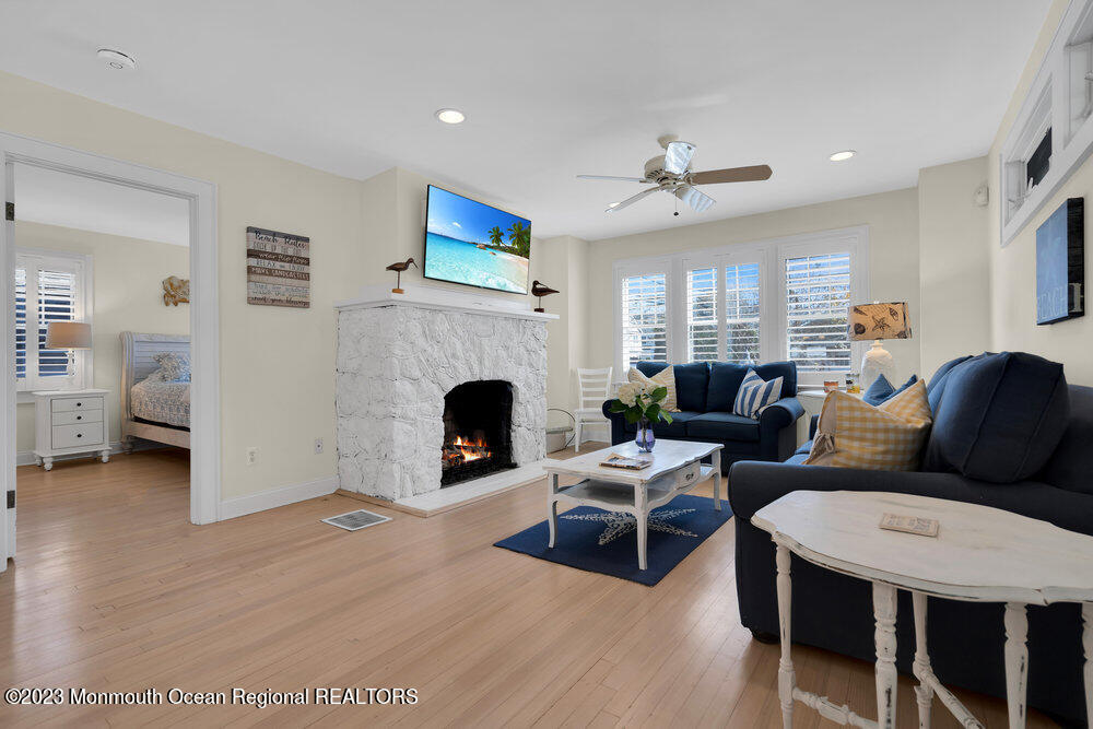 303 B Street Belmar, NJ 07719 - Photo 13 of 78 a living room with furniture a fireplace and a flat screen tv