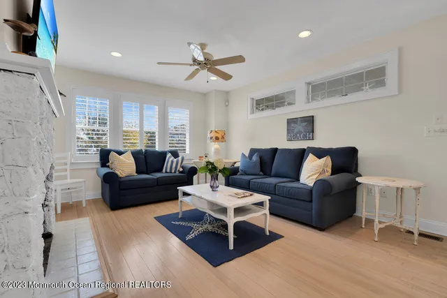 a kitchen with stainless steel appliances kitchen island granite countertop a refrigerator a stove a microwave oven a sink with island and chairs