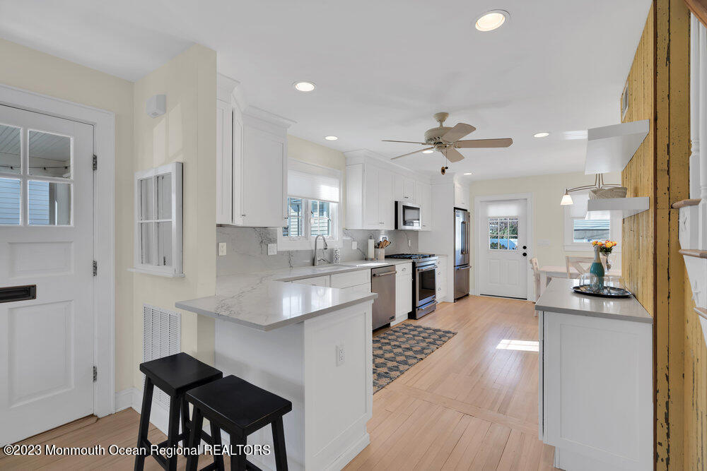 303 B Street Belmar, NJ 07719 - Photo 16 of 78 a large white kitchen with granite countertop lots of counter top space and stainless steel appliances