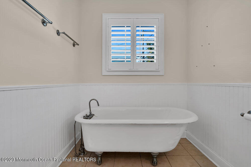 303 B Street Belmar, NJ 07719 - Photo 32 of 78 a white bath tub sitting next to a window