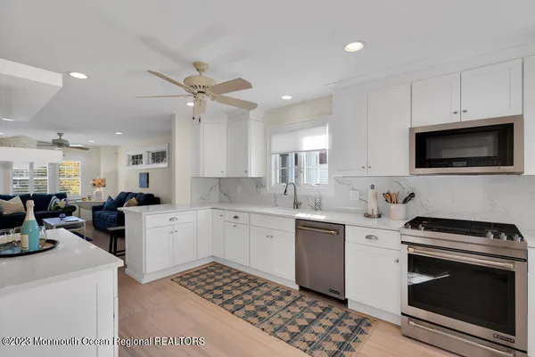 a view of a hallway with furniture and stairs