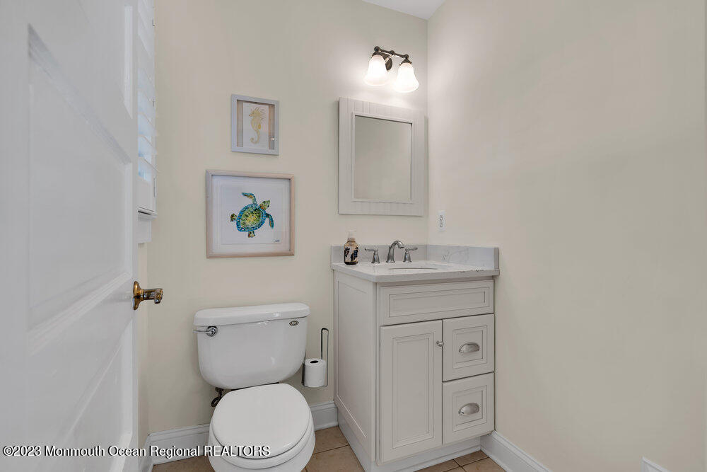 303 B Street Belmar, NJ 07719 - Photo 34 of 78 a bathroom with a toilet sink and mirror