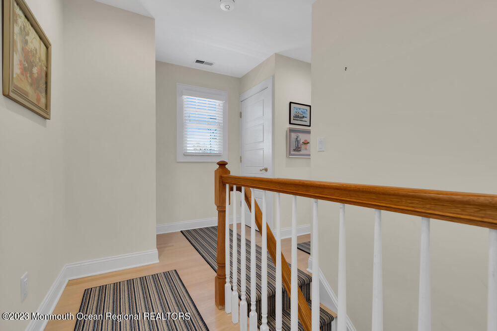 303 B Street Belmar, NJ 07719 - Photo 37 of 78 a view of a hallway with wooden floor and staircase