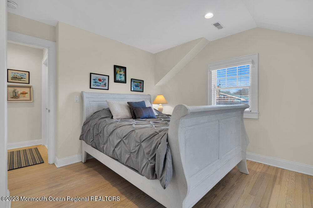 303 B Street Belmar, NJ 07719 - Photo 40 of 78 a bedroom with a bed and night stand