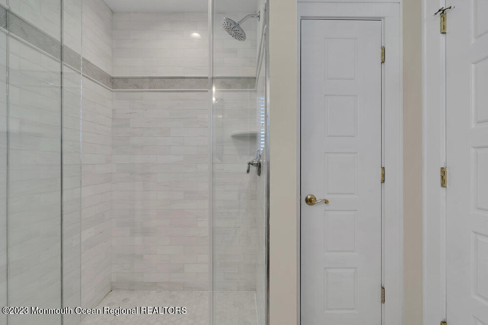 303 B Street Belmar, NJ 07719 - Photo 50 of 78 a bathroom with a glass shower door
