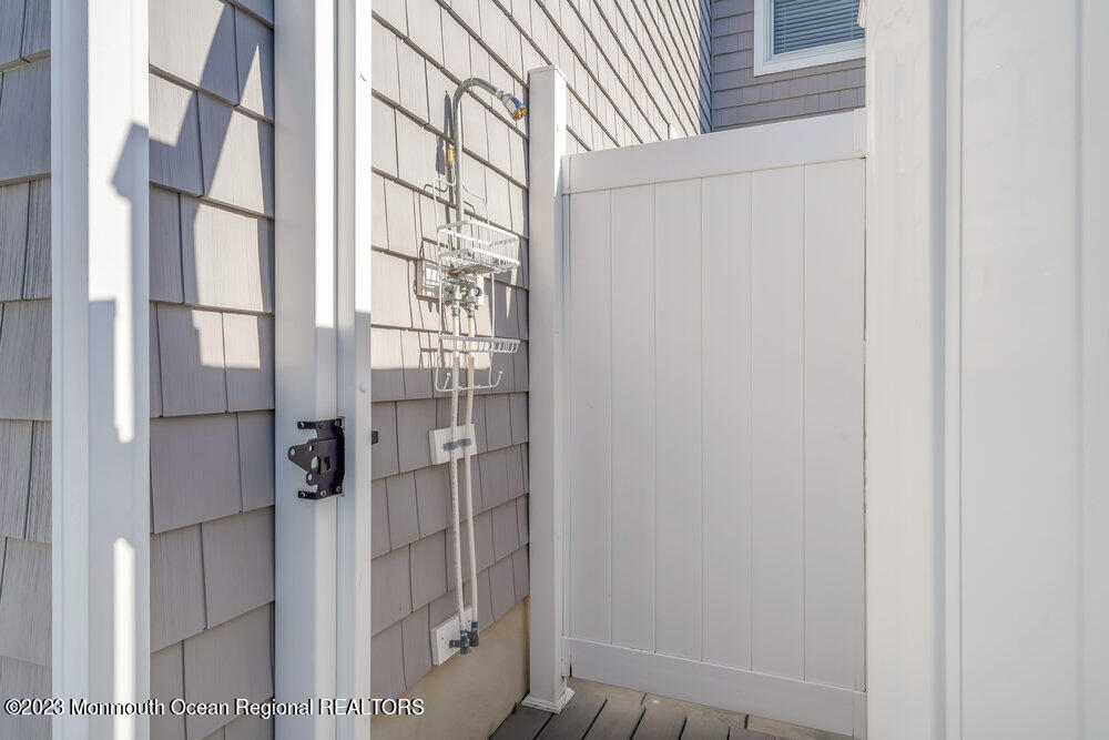 303 B Street Belmar, NJ 07719 - Photo 55 of 78 a bathroom with a glass door shower and a sink