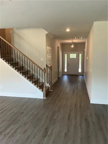 a view of a hallway with wooden floor