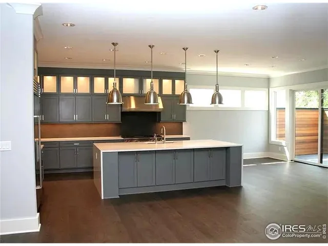 a kitchen with a stove a refrigerator and a sink