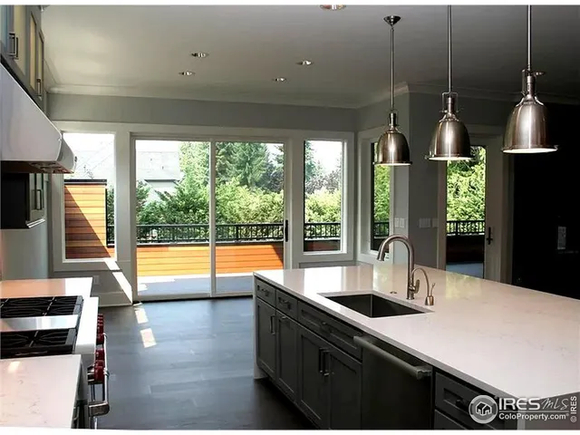 a kitchen with stainless steel appliances a sink a stove and a refrigerator