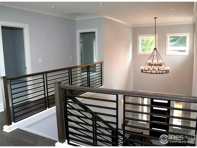a view of an empty room with a window and a fireplace