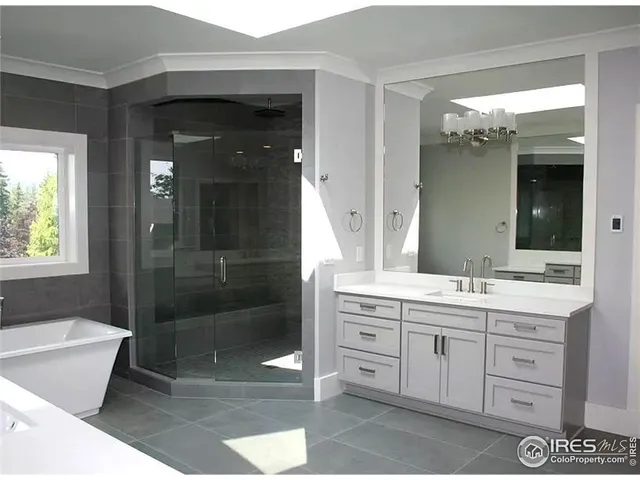 a bathroom with a double vanity sink mirror and bathtub