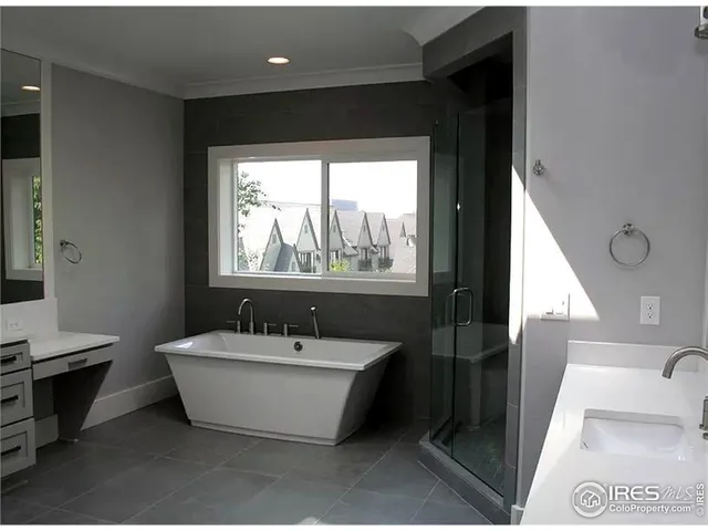 an empty room with windows and fireplace