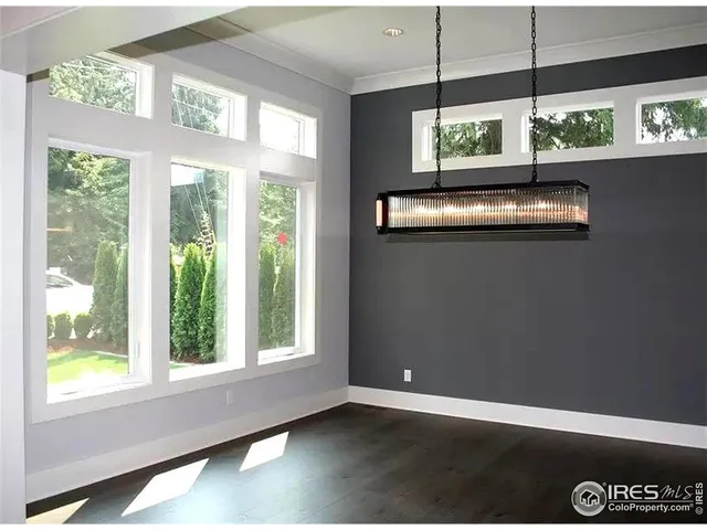 a view of a hallway with staircase and white walls