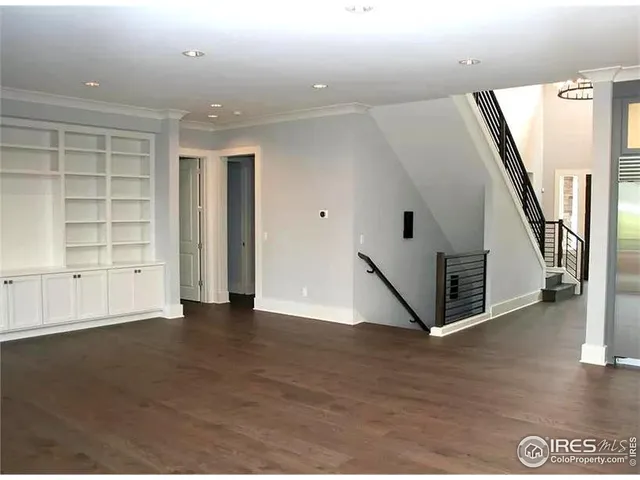 a view of kitchen with stainless steel appliances granite countertop a refrigerator and a sink