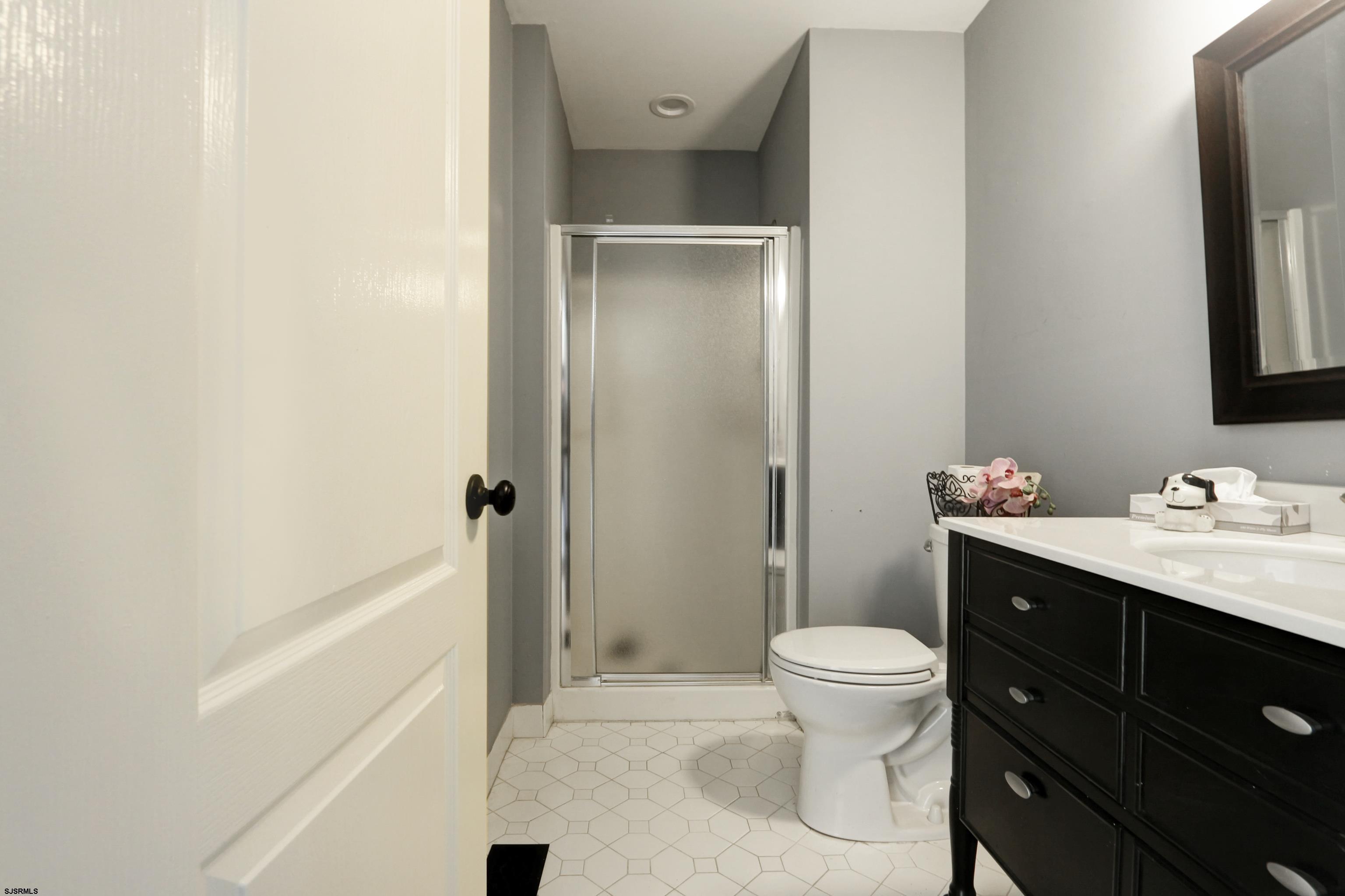 1860 Franklin Boulevard Linwood, NJ 08221 - Photo 21 of 39 a bathroom with a sink a toilet and shower