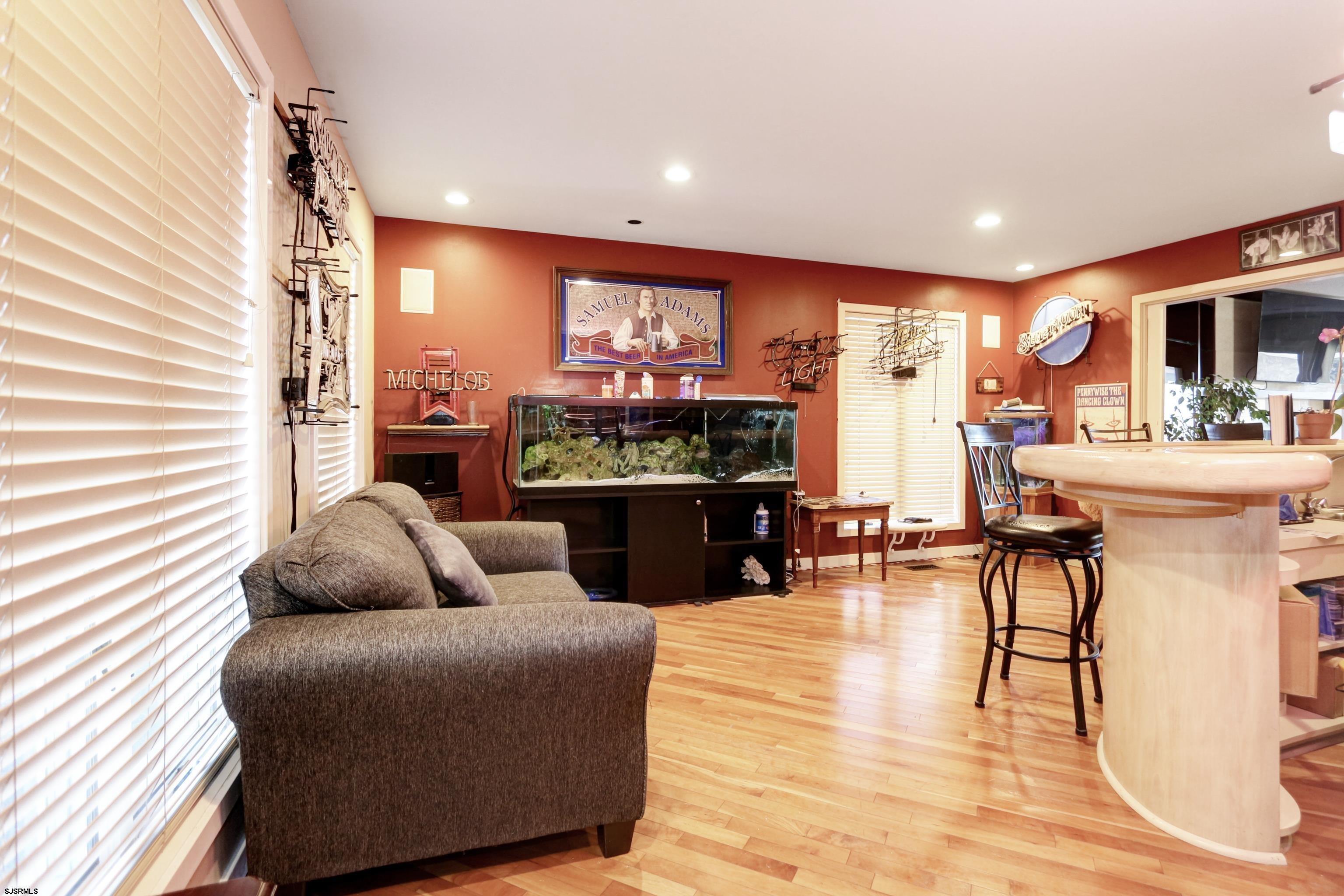 1860 Franklin Boulevard Linwood, NJ 08221 - Photo 27 of 39 a living room with furniture a floor to ceiling window and a flat screen tv